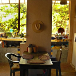 Dining table inside with kitchen in the back