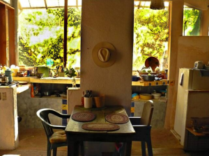 Dining table inside with kitchen in the back